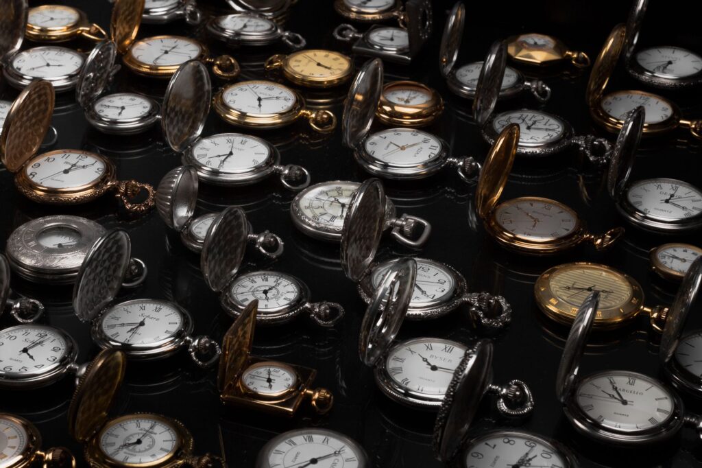 An exquisite display of various vintage pocket watches with intricate designs and metallic finishes.