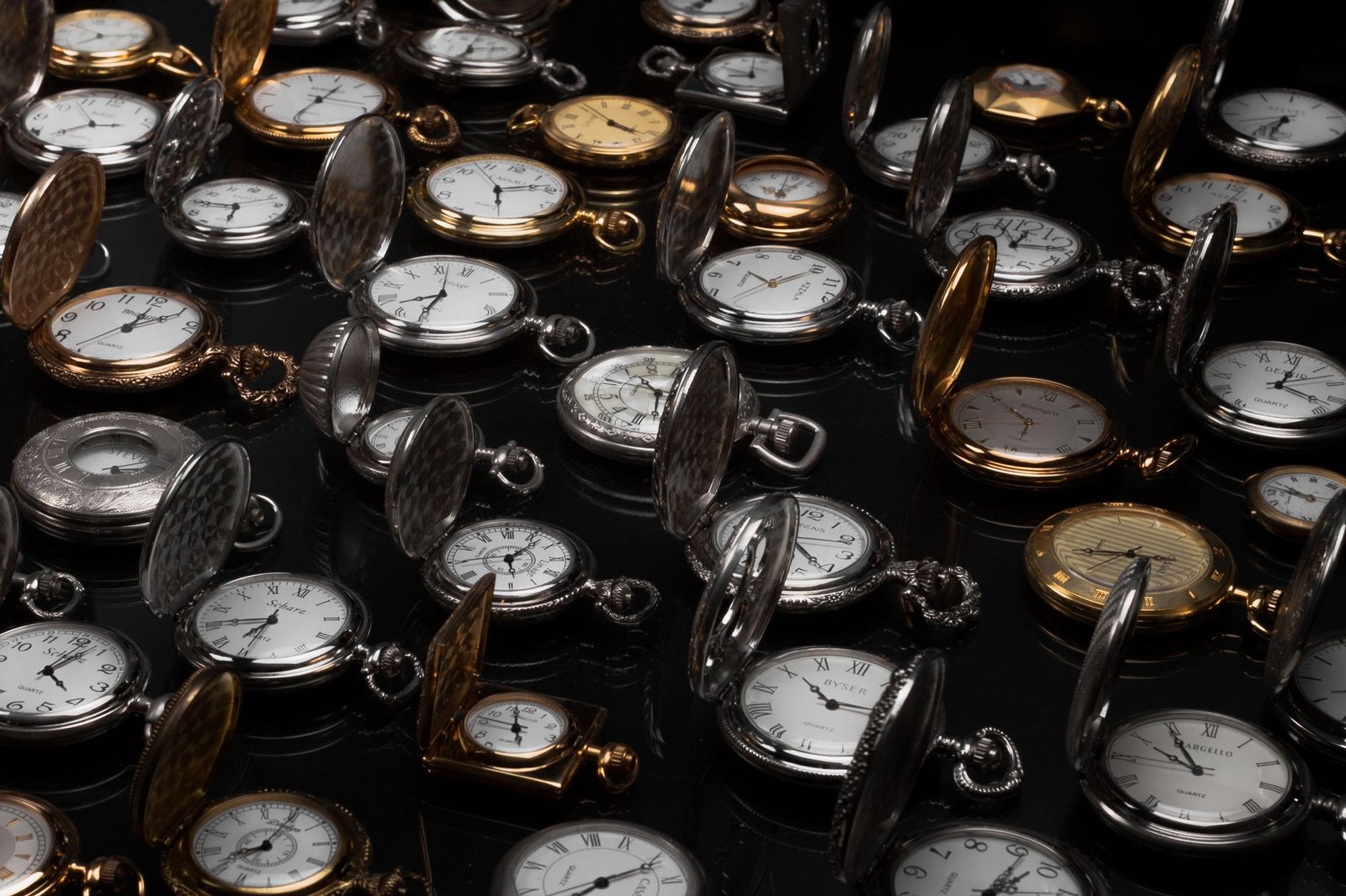 An exquisite display of various vintage pocket watches with intricate designs and metallic finishes.