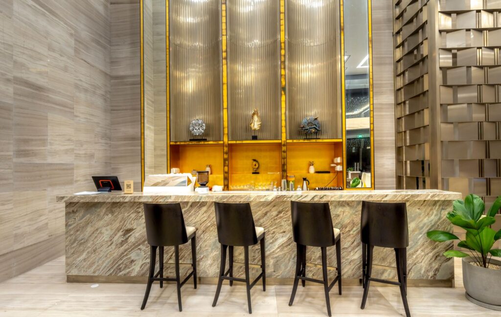 A luxurious and modern bar counter with stylish stools in a hotel's elegant interior design.