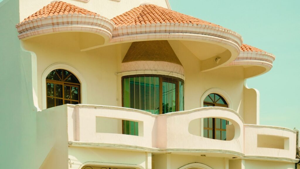 Close-up of a Mediterranean-style villa with unique architectural design and terracotta roof.