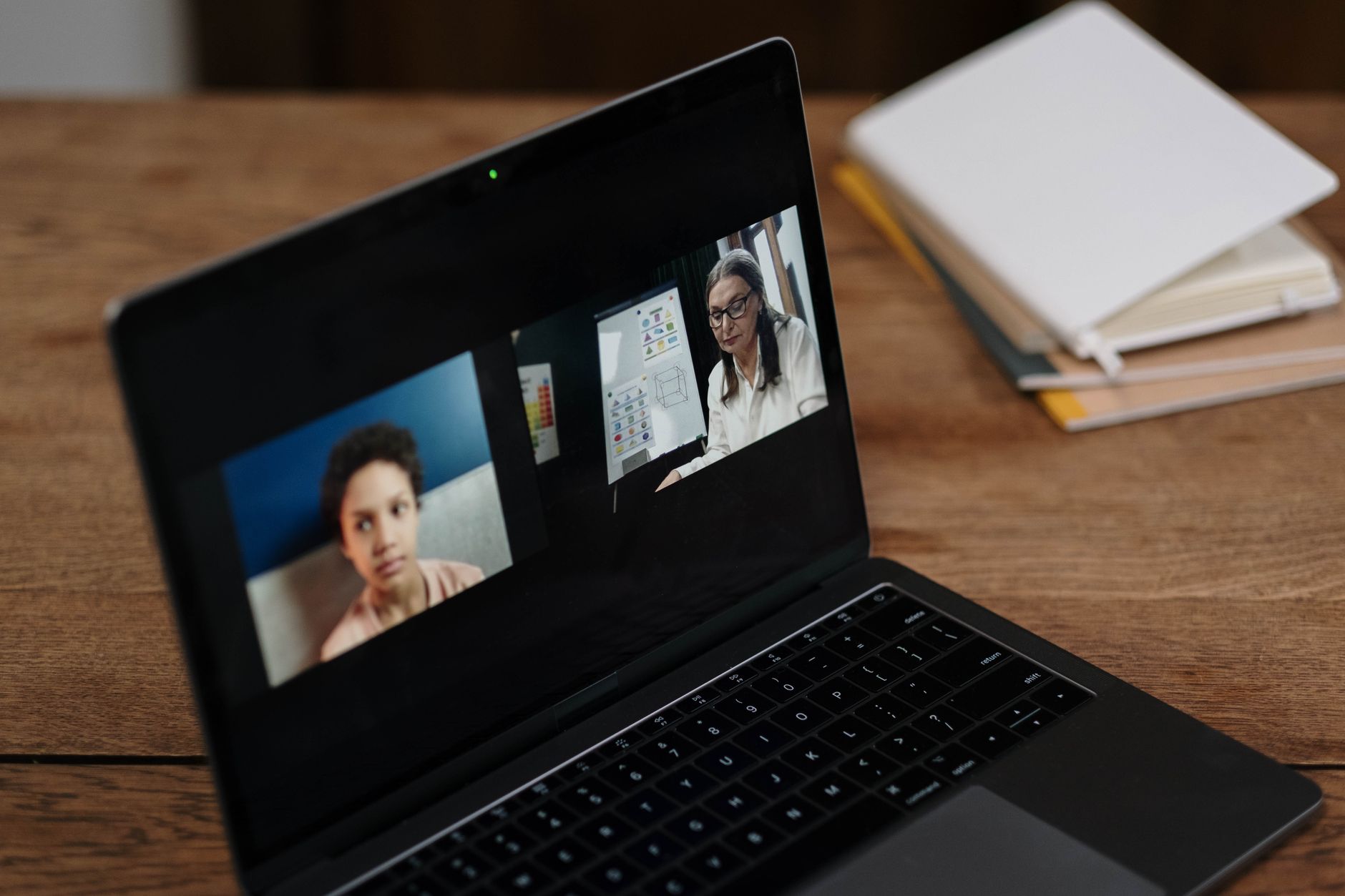Two people engaging in online education via a laptop, perfect for illustrating virtual learning.
