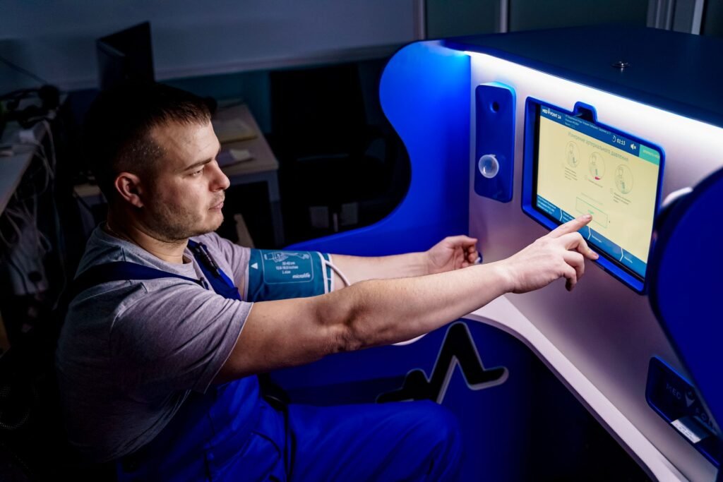A man uses a touch screen for a telemedicine health check in a modern setting.