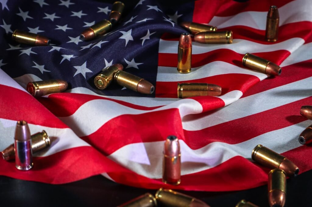 American flag draped with bullets, symbolizing patriotism and force.