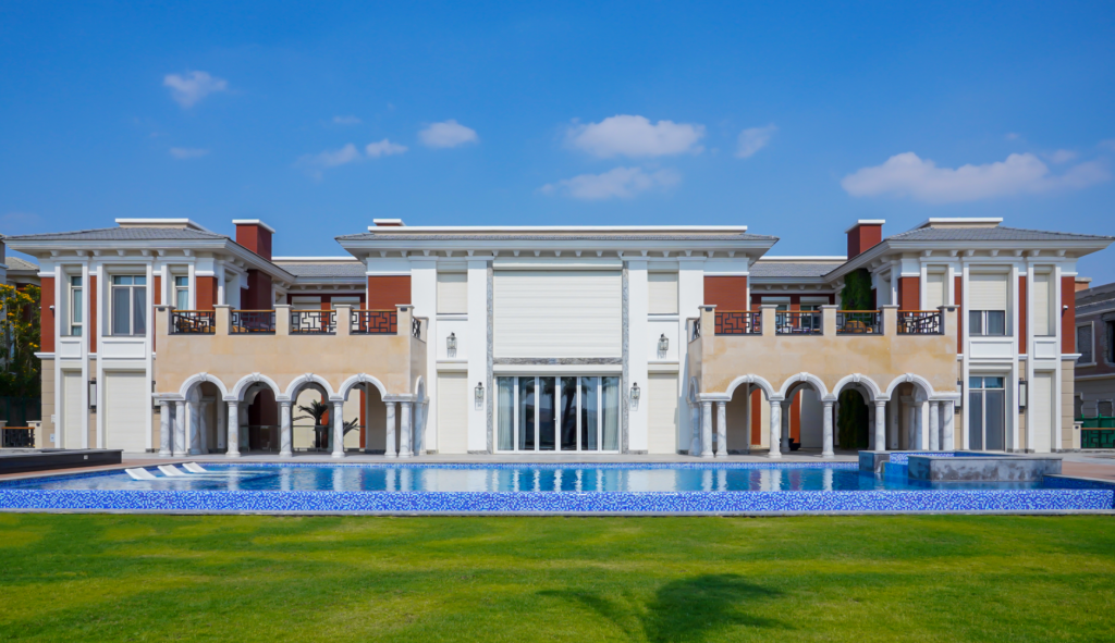 Elegant villa with swimming pool and green lawn in Cairo, showcasing luxury architecture.