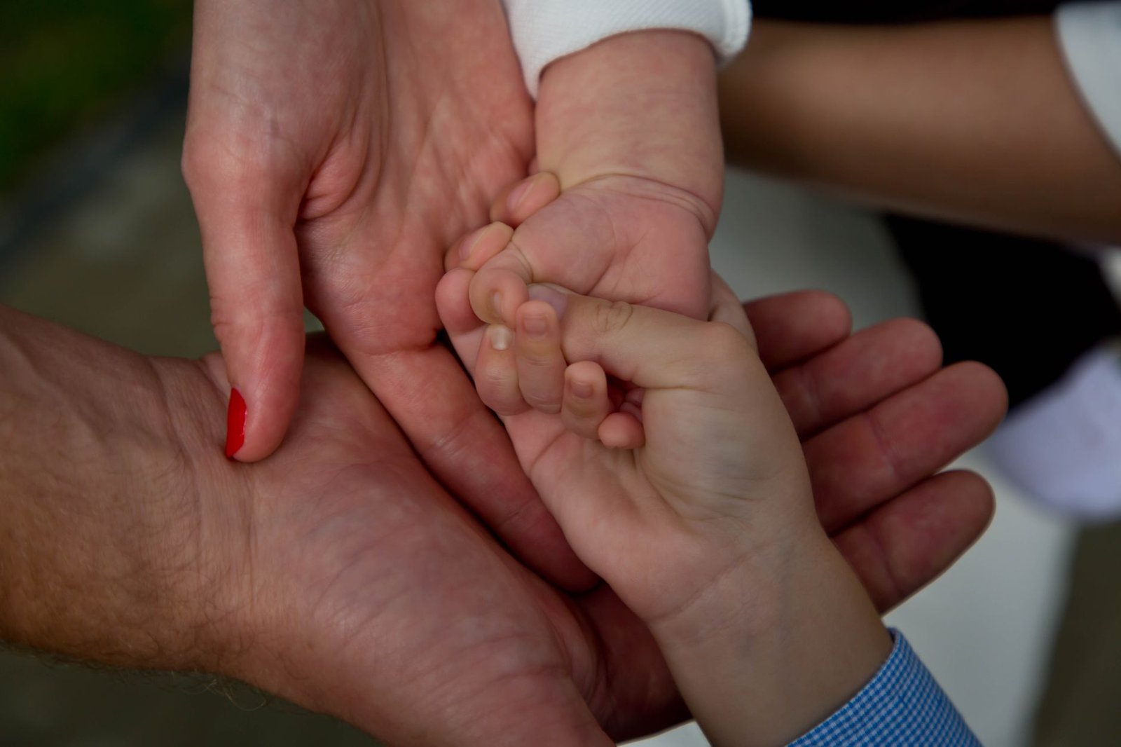 Close-up of a family joining hands, symbolizing love and connection.