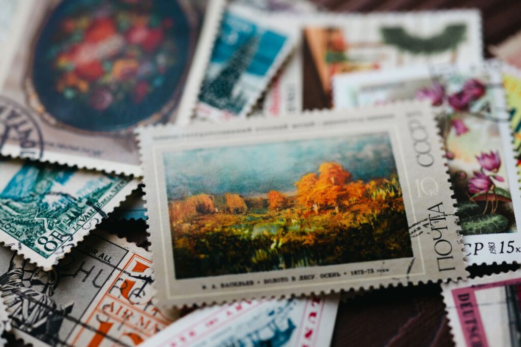 Assorted vintage postage stamps featuring diverse art and designs in a close-up view.