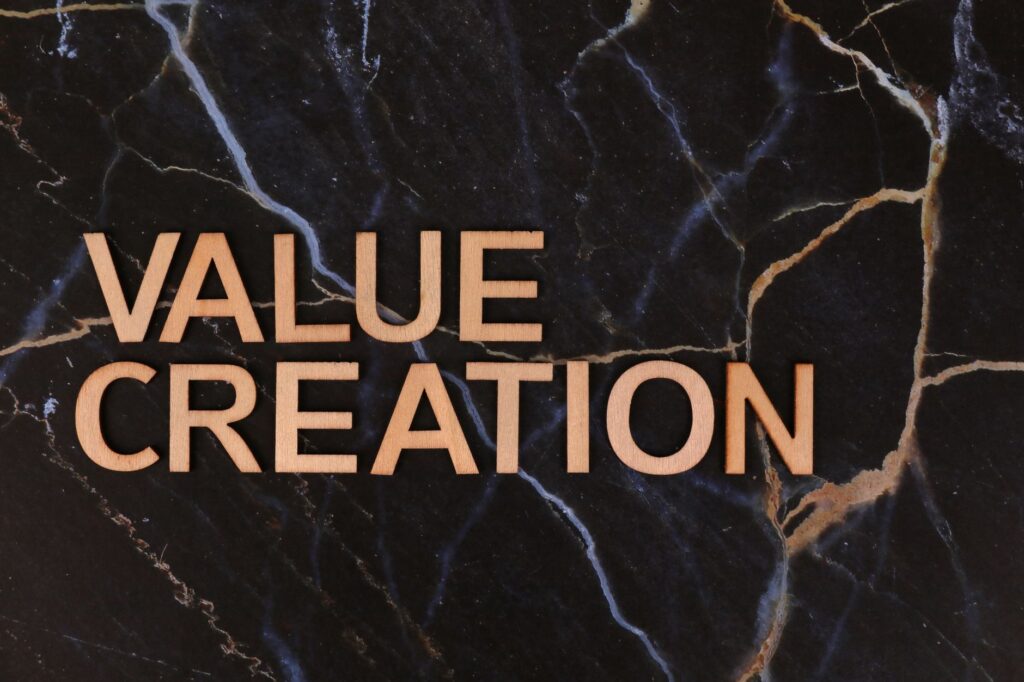 Wooden letters spelling 'Value Creation' on dark marble background, perfect for business themes.