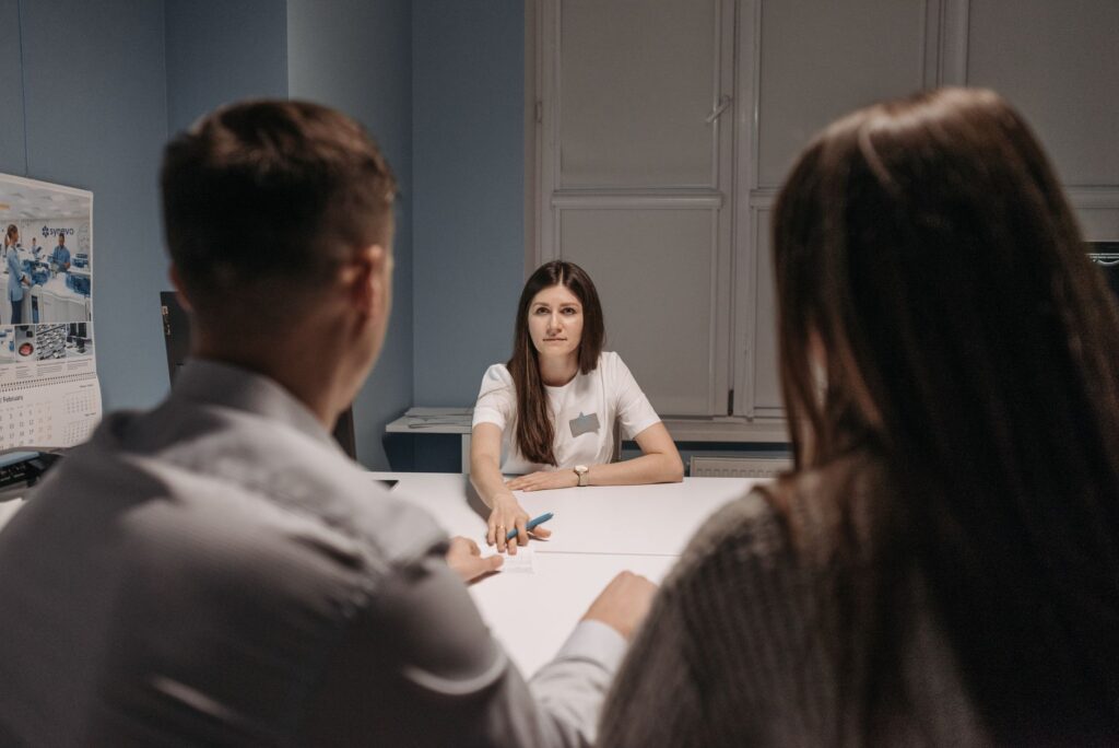 Professional meeting in a healthcare office setting with medical staff discussion.