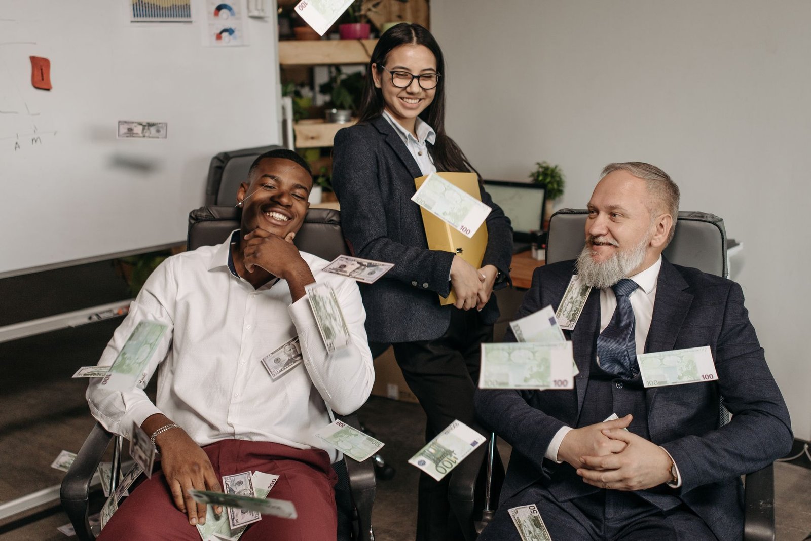Office scene of diverse business professionals with money scattered, creating a playful environment.