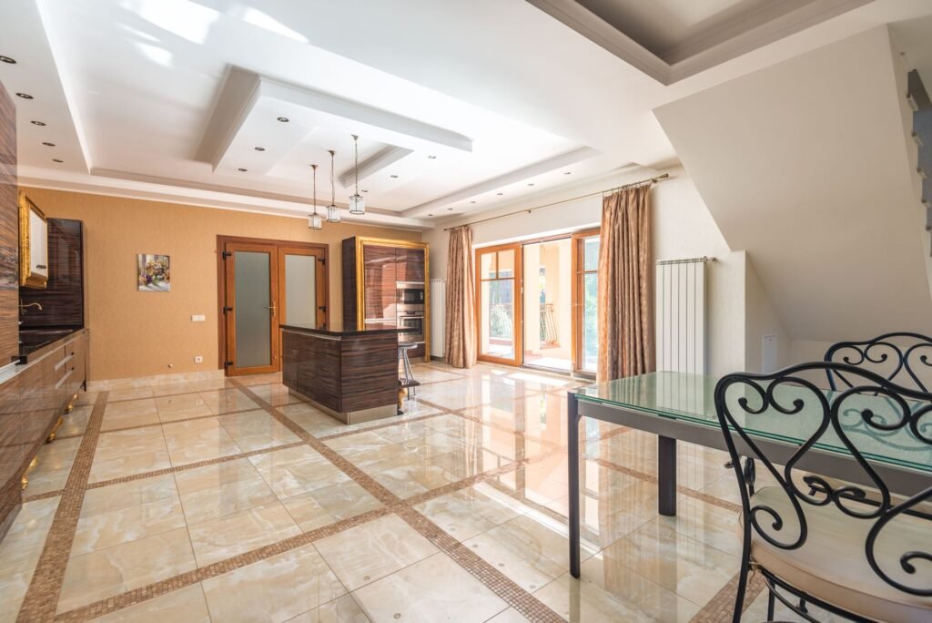 Spacious and modern kitchen interior with elegant design and bright natural lighting.