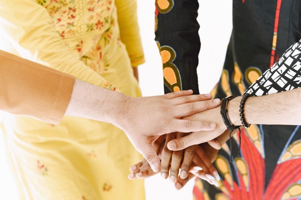 Close-up of diverse hands stacked, symbolizing teamwork and unity.