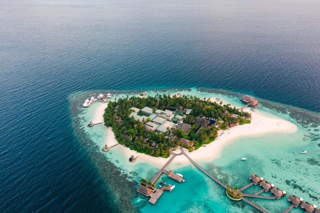 Discover a breathtaking tropical island resort surrounded by azure waters and lush greenery.