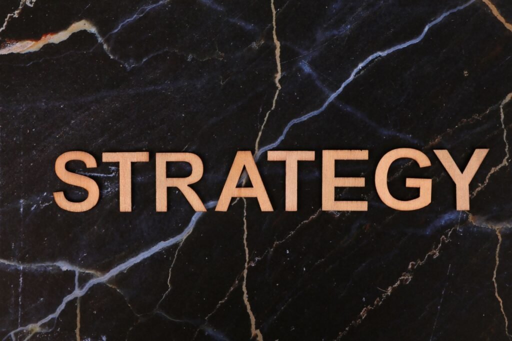 Strategic planning concept with 'Strategy' in wooden letters on dark marble.