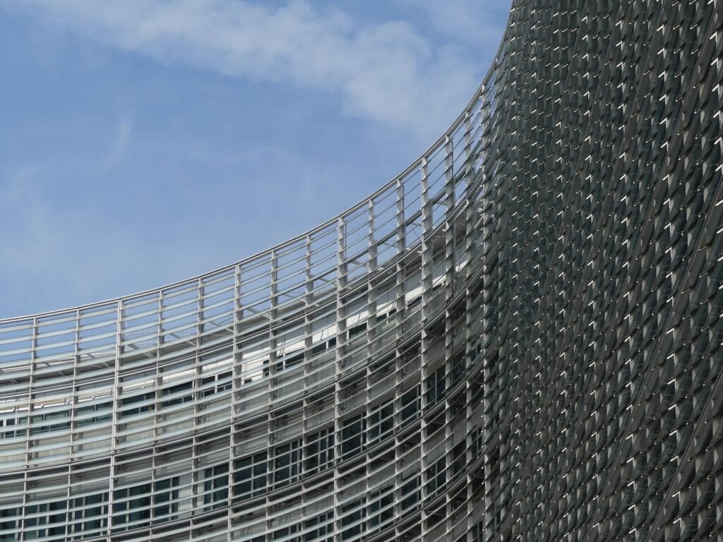 Curved facade of the European Commission building in Brussels under a clear sky.
