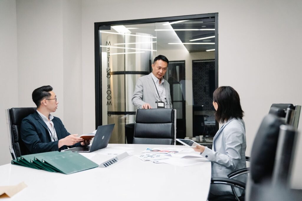 Business professionals in a meeting room engaged in teamwork and strategic planning.