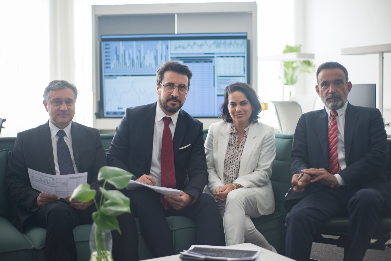 Professional team in corporate attire ready for a meeting, engaged in discussion.